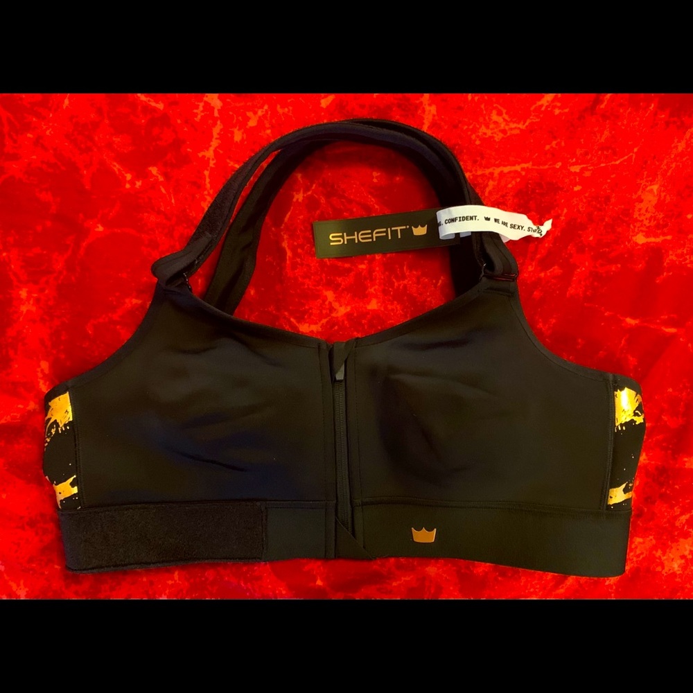 SHEFIT flex sports bra. Black with gold design.